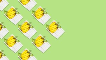 Background with bananas with leaves in a white wooden box and copy space photo