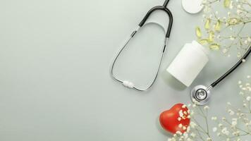 Bottle with supplements for heart, stethoscope and heart shape with copy space photo