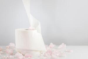 Roll of natural white toilet paper on a light background with copy space photo