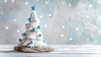 Handmade knitted Christmas tree adorned with blue ornaments photo