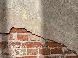 Broken brick wall with shadow. Aged wall. Vintage background photo