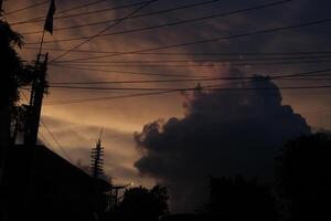 Purple Sky With Clouds And Trees In The Foreground photo