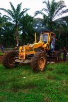 Kalimantan Timur, Indonesia 11 September 2024. The grader machine used to level the road is in operation photo