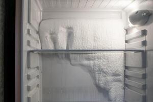 Frozen refrigerator that needs to be defrosted. photo