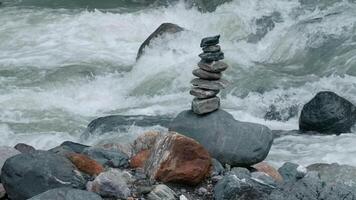 Huge streams of water flowing downstream. Creative. Close-up shooting with cold waters that beat against the rocks of the bottom. video