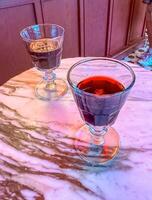 two glasses with red cherry drink in cafe . High quality photo