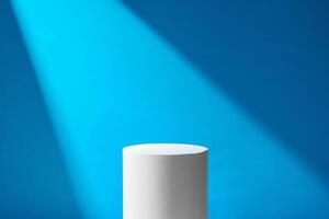 A minimalistic podium illuminated by a beam of light against a blue backdrop in a studio setting photo