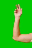 Hand Gesture Above Arm Against Bright Green Background photo