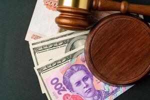 Money banknotes with judge gavel. Corruption concept with currency of Russian Rubles, Ukrainian Hryvnia and American Dollars photo