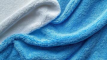 Soft white and blue microfiber towels arranged together on a surface, showcasing texture and color contrast in natural light photo