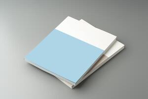 A stack of blank notebooks arranged neatly on a simple grey background photo