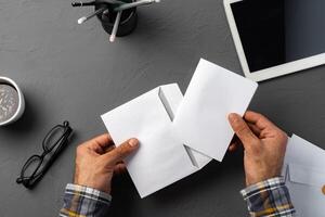 Business correspondence. Top view of man hands holding mockup envelope with letter. Copy space. photo
