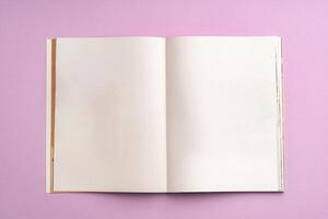 view of notebook with blank pages on a pink background photo