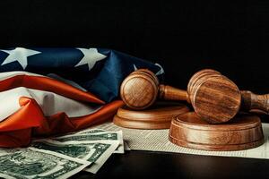 Wooden judge mallet with Dollars notes on the USA flag with Declaration of Independence photo