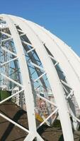 Top view of white domed structure. Stock footage. Beautiful modern building in city center in summer. Architecture of modern circus dome made of white metal arches video