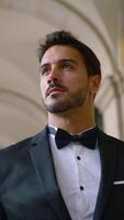 Attractive man with beard in suit. Action. Young elegant man in suit at old building. Gorgeous man with beard and suit video