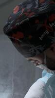 Side view of a surgeon at work in operating room. Action. Medical devices for the surgery. video