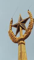 Soviet symbol, golden spire on a cloudy sky background. Stock footage. Golden star and ears of wheat. video