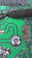 Microcircuit being fixed with soldering iron. Computer repair concept. Tweezers with chip and soldering Iron. soldering iron and microcircuit video
