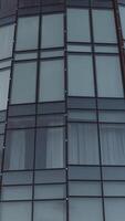 Top view of glass modern building with reflection. Stock footage. Beautiful reflection in glass facade of modern building. Glass height with landscape reflection video