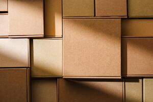 Stacked cardboard boxes arranged in a neat pattern under natural light photo