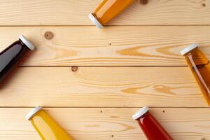 Juice bottles on wooden background flat lay photo
