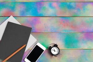 smartphone, tablet, notebook pen on the background of a wooden table photo