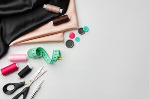 Crafting essentials for sewing projects displayed on a table with fabric, threads, and tools photo