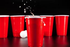Cups for game Beer Pong on the table photo