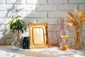 Photo frames on a brick wall background on the table with wheat ears in vase
