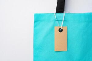 Eco bag for shopping with blank tag on white background photo