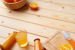 Fresh orange juice in the glass with orange fruit on wooden background photo