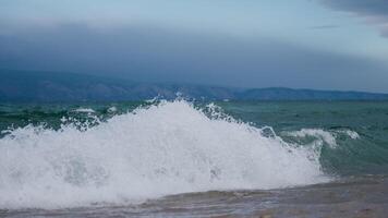 the shore of Lake Baikal with a sandy shore and small waves video