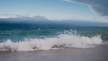 the shore of Lake Baikal with a sandy shore and small waves video