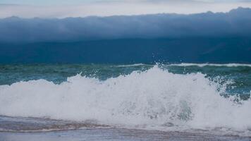 the shore of Lake Baikal with a sandy shore and small waves video