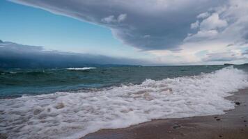 the shore of Lake Baikal with a sandy shore and small waves video