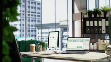 Modern corporate environment in an urban downtown building, high end workspace with business analytics and reports running on screen. Successful career development, office life. Camera B. video