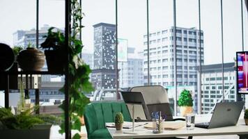 Empty modern corporate high end office space designed for a CEO or person with authority, running analytics and reports on screen. Urban global enterprise workspace, empowerment. video
