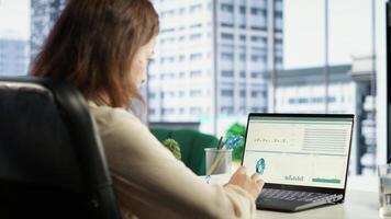 Female entrepreneur working on financial planning and budget allocation, ensuring the company resources are used effectively to achieve maximum profit and long term business objectives. Camera B. video