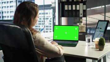 Woman chief executive officer working with mockup copy space screen on device, developing a project for enterprise growth and objectives achievement. Female director with determination. Camera A. video
