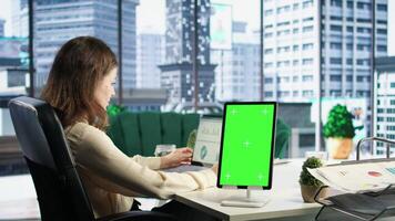 Young business manager working with isolated copy space on her tablet, working on financial planning with data analytics on laptop. Developing a strategy to increase funding for success. Camera A. video