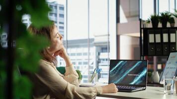 Young entrepreneur with leadership skills creates a financial report, demonstrating her expertise in analysis, forecasting and ensuring the company stability. Strategic thinking in office. Camera B. video