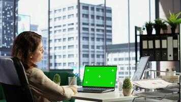 Woman chief executive officer working with mockup copy space screen on device, developing a project for enterprise growth and objectives achievement. Female director with determination. Camera B. video