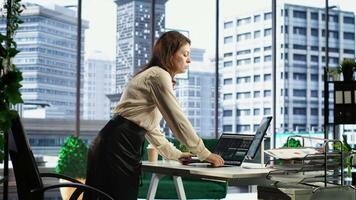 Businesswoman with leadership skills creates a financial report, demonstrating her expertise in analysis, forecasting and ensuring the organizational stability within market conditions. Camera B. video
