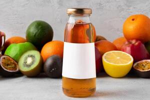 Various fruits and freshly squeezed fruits juice in bottle on gray background photo