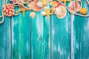 Different sea shells on color wooden background photo