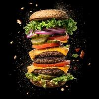 An explosive, dynamic image of a burger bursting apart against a black background. The burger features a juicy beef patty, layers of melted cheese, all flying outward from the center of the explosion. photo