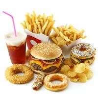 A variety of fast food and junk food items displayed together on a clean white background. The assortment includes a juicy cheeseburger with melted cheese and fresh toppings. photo