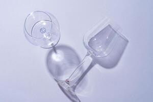 Two empty wine glass on gray background top view photo