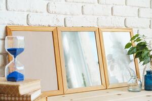 Wooden frame mockup on table with modern vase and books photo